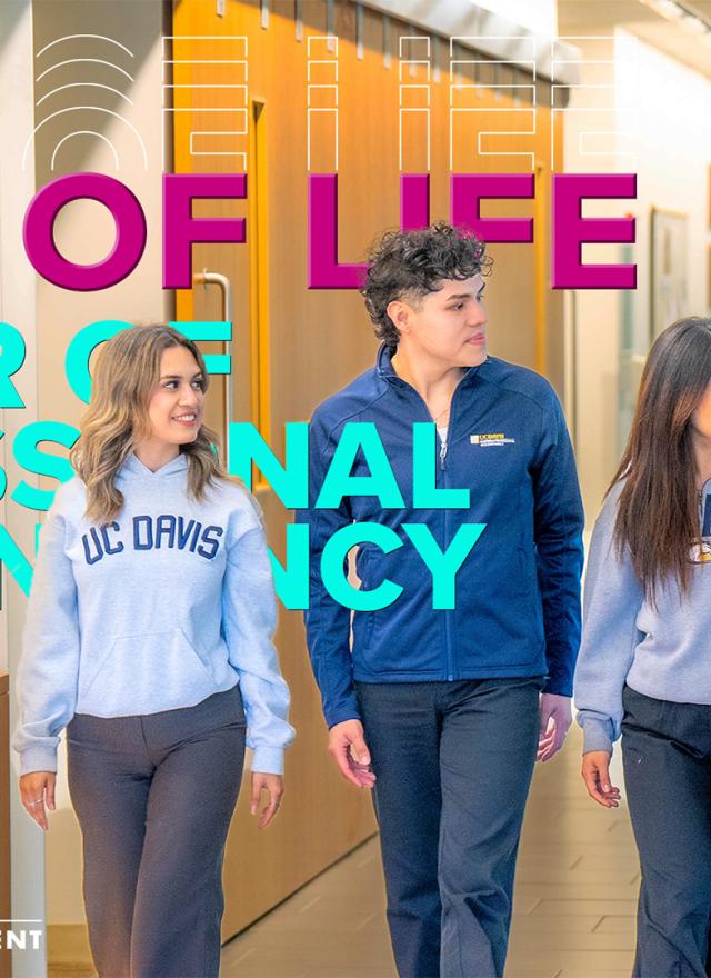 Four students wearing UC Davis sweaters in Gallagher Hall