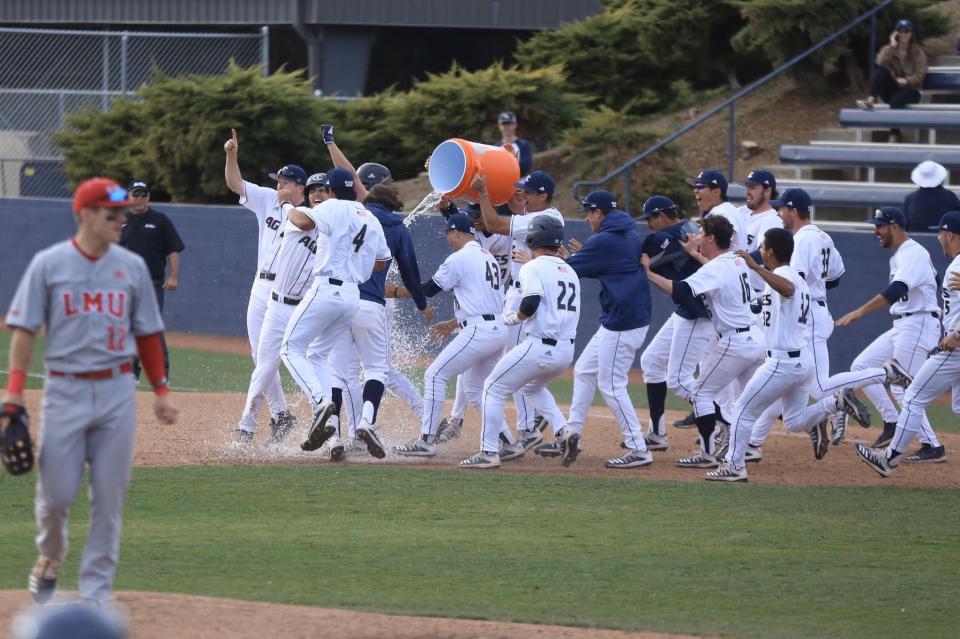 Wyatt Tucker and the Aggies baseball team celebrate a win.