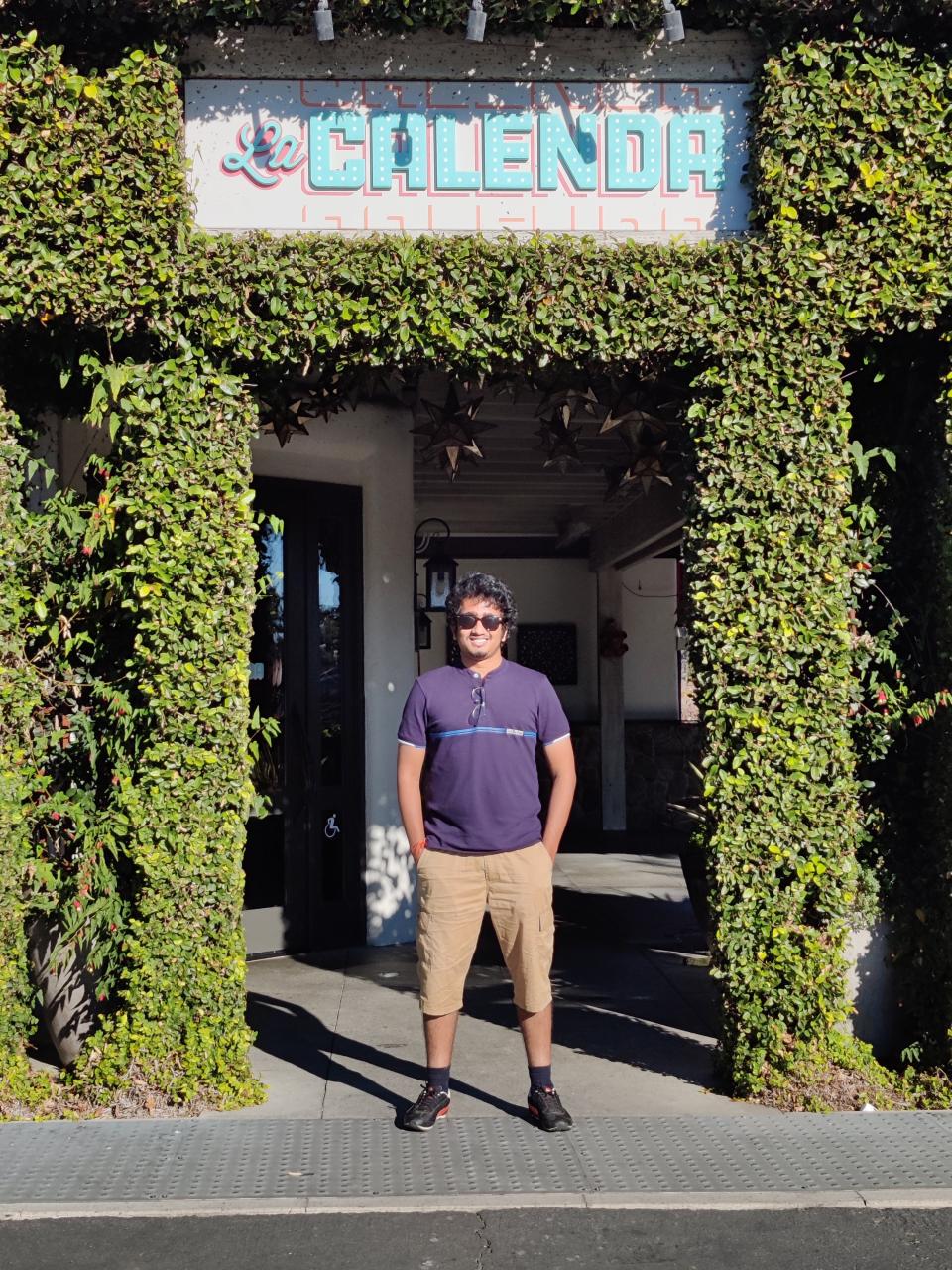 Keshore Suryanarayanan in front of La Calenda restaurant 