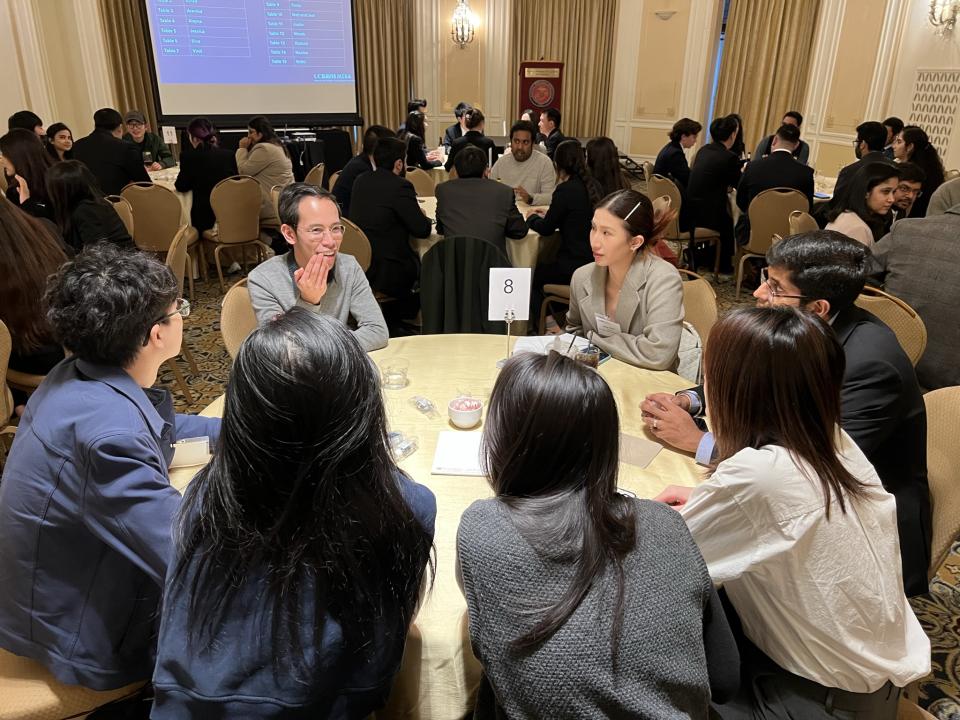 group of people sitting at a round table