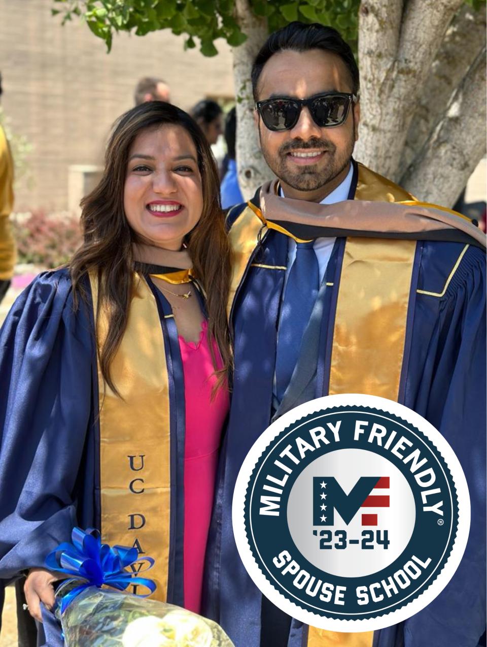 Two MBA students and who are husband and wife pose in graduation robes