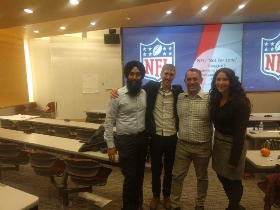 Harkeerat Toor, Kyle Vander Molen, Ryan Swinney and Andrea Ellinghouse posing for a photo in a classroom