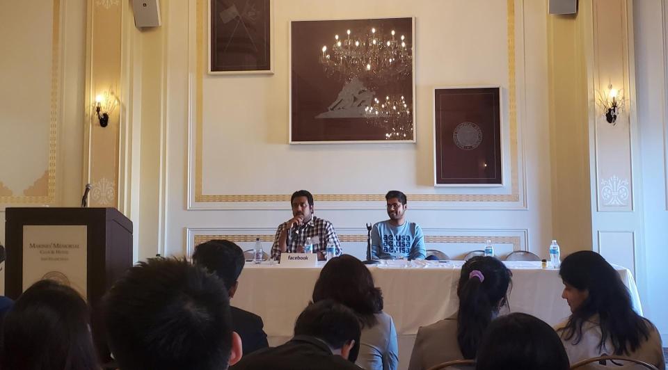 Panelists Sonic Prabhudesai and Sharad Jain speaking to a group