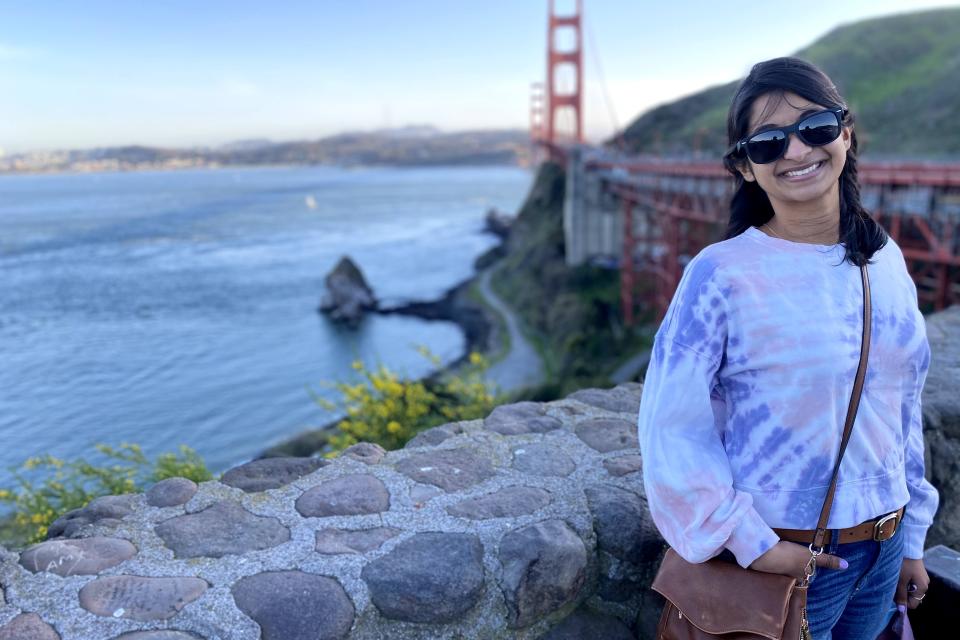 Woman standing in front of the Golden Gate bridge in San Francisco